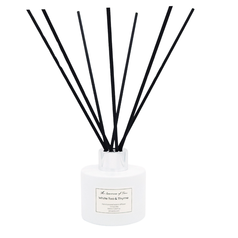 White Tea and Thyme scented diffuser in a white glass jar with black fiber reeds.