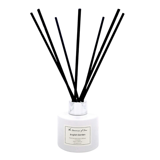 English Garden reed diffuser in a white jar with silver lid and black fibre reeds.