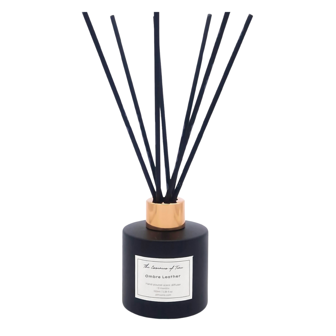 Ombre Leather scented reed diffuser in black glass jar with rose gold cap and black fibre reeds for home fragrance.