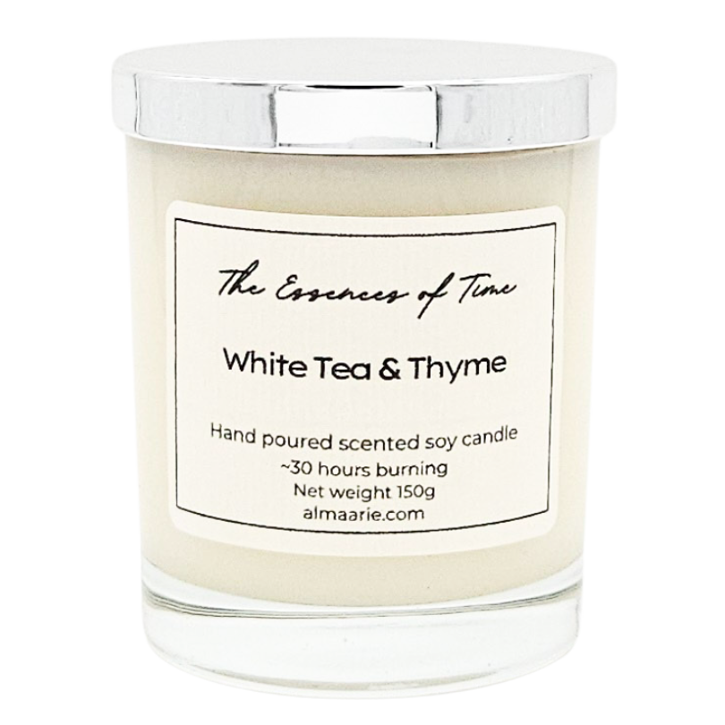 White Tea and Thyme scented candle in clear glass jar with silver lid for gifting.