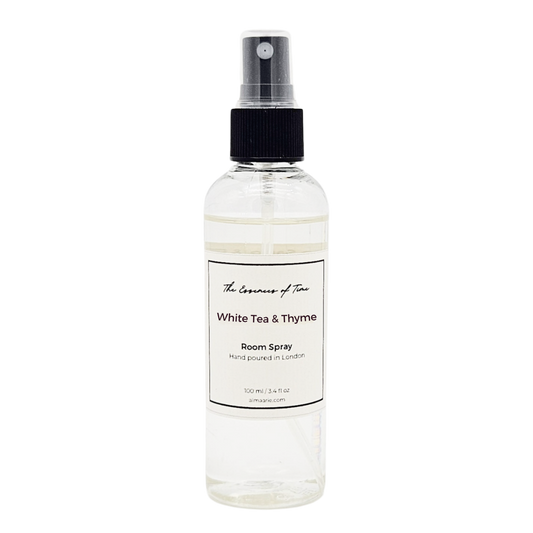 Clear room spray bottle labeled 'White Tea & Thyme' on a white background